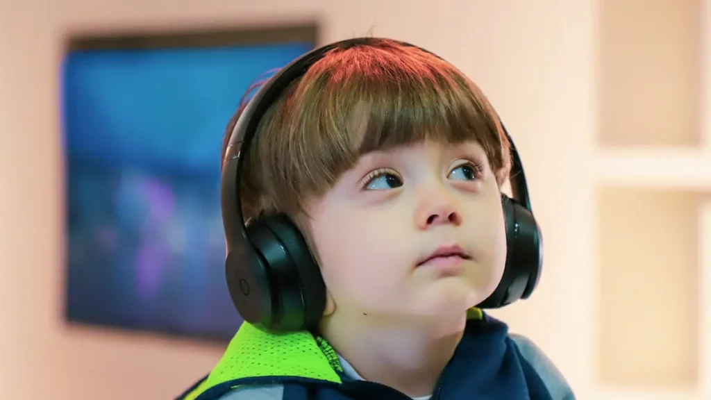 Child With Headphones Listening To Music