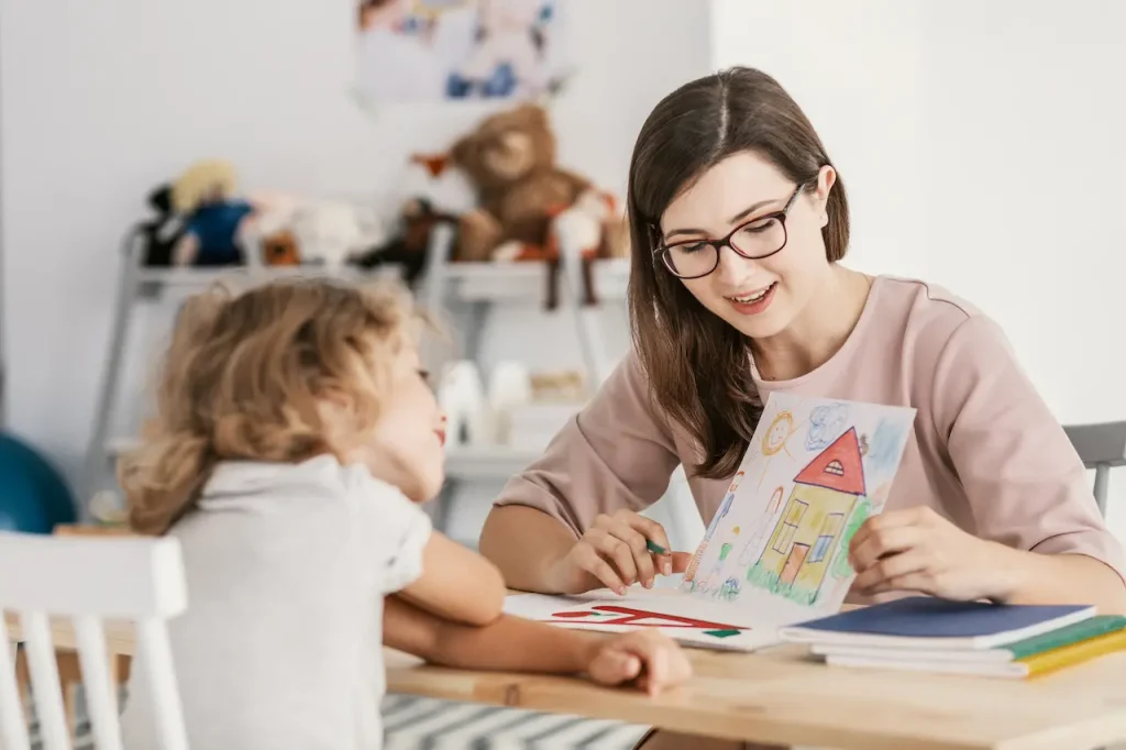 Early Signs of Autism Woman Teaching A Kid How To Draw