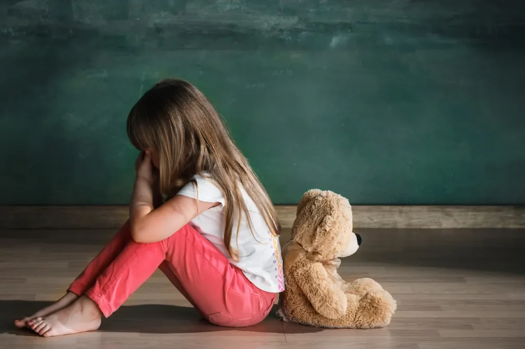 Girl Sitting on the Floor with the Teddy Bear 