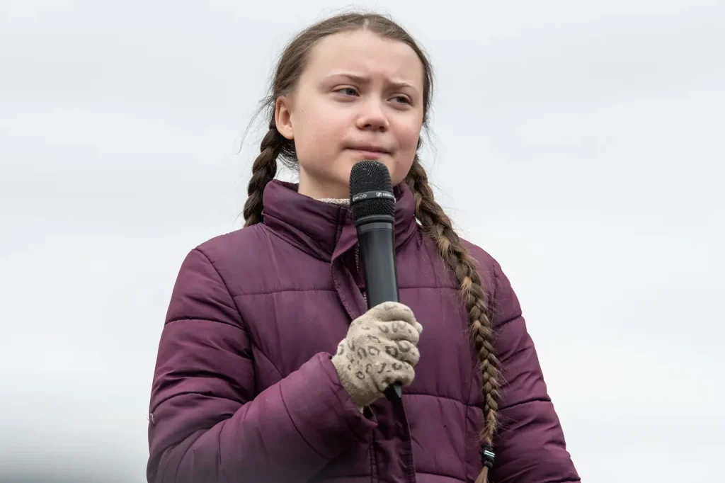 Greta Thunberg Holding A Microphone