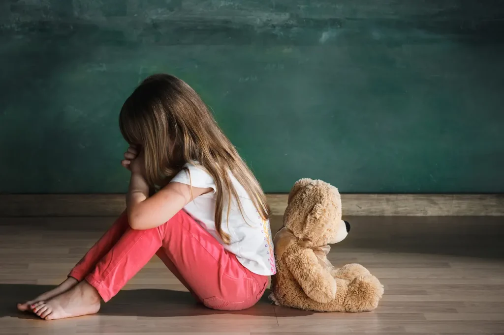 Little Girl With a Teddy Sitting On The Floor