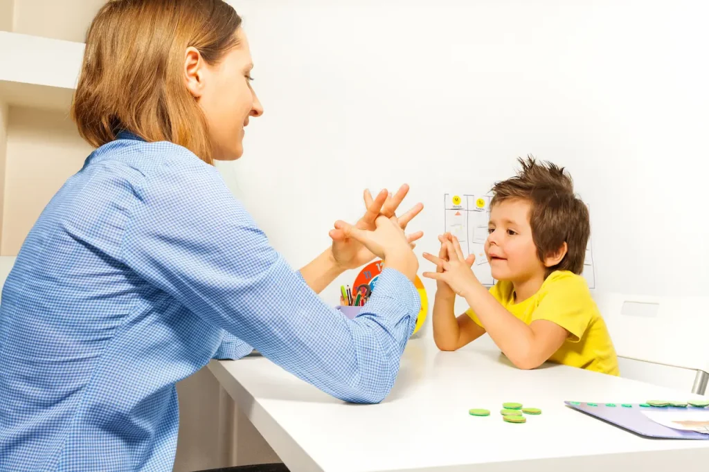 The Therapist Teaching the Kid to Exercises its Fingers 