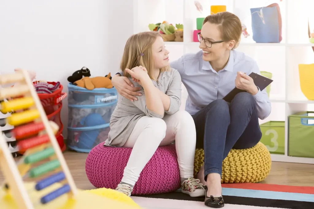 Therapist Talking With A Child That Has Autism 