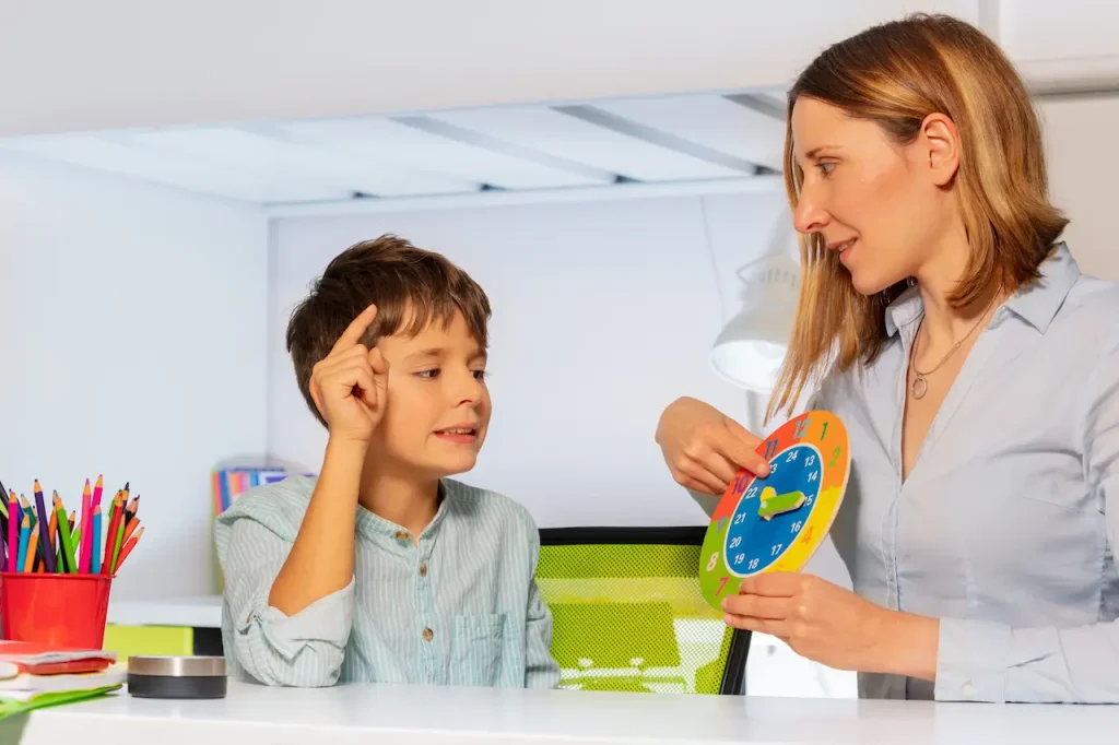 Woman Teaching a Boy With Autism Clock And Hours