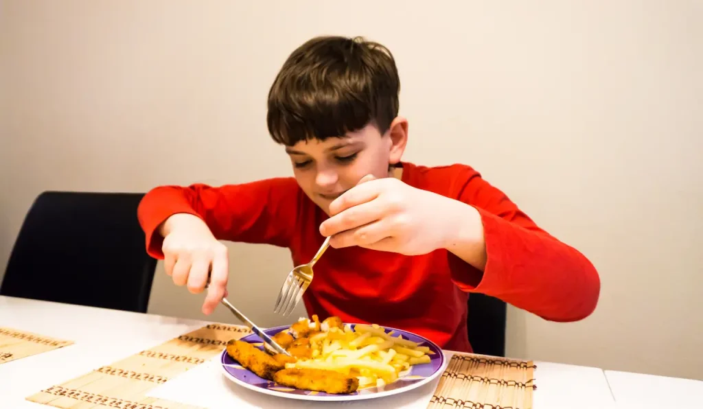 Young Man Eating at the Table