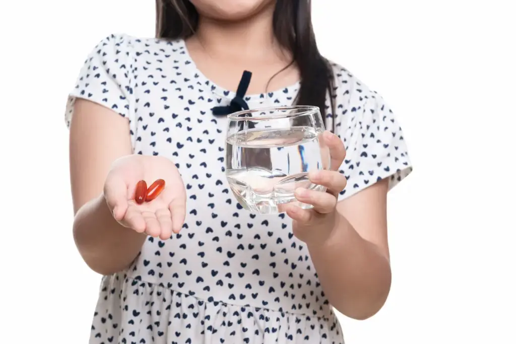 Girl Holding a Glass and Supplement